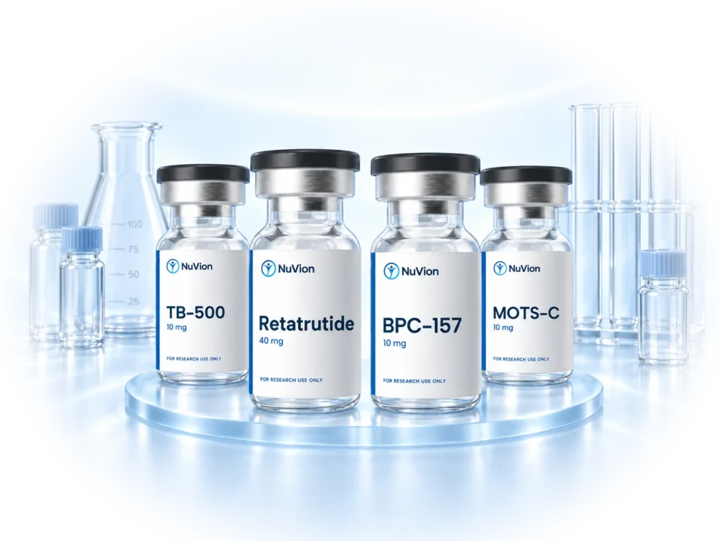 Four NuVion Health research peptide vials, TB-500, Retatrutide, BPC-157 and MOTS-C, on a glass stand with laboratory glassware